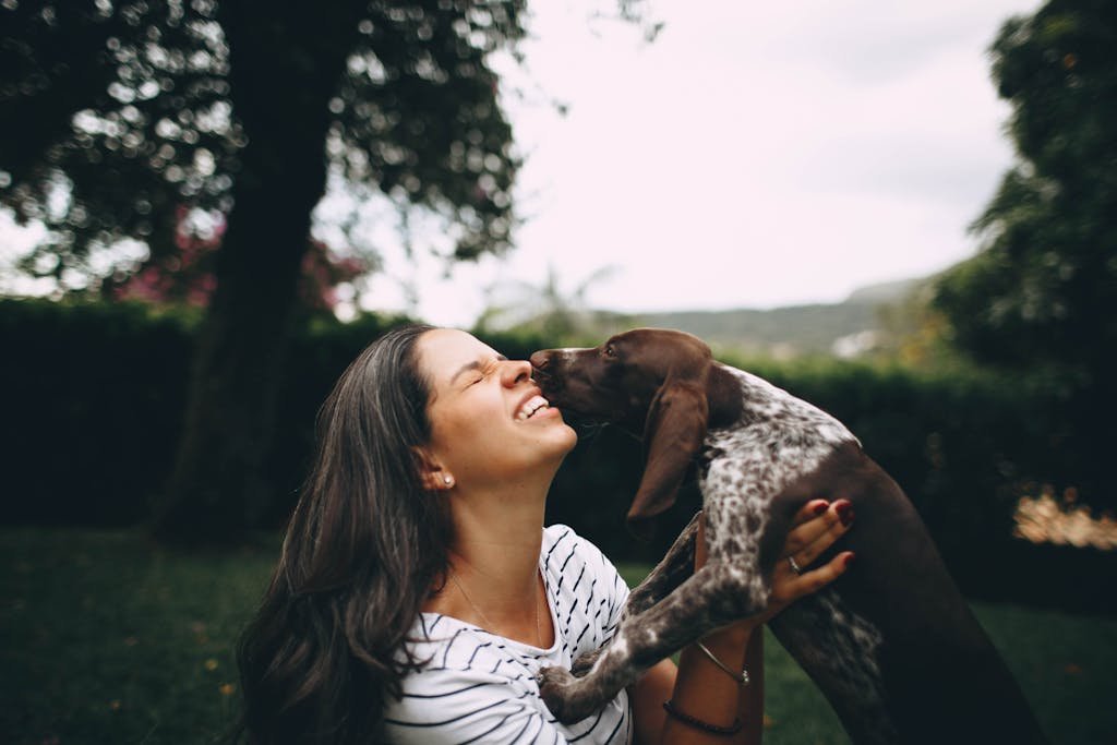 Woman and her playful dog enjoying a blissful moment outdoors.